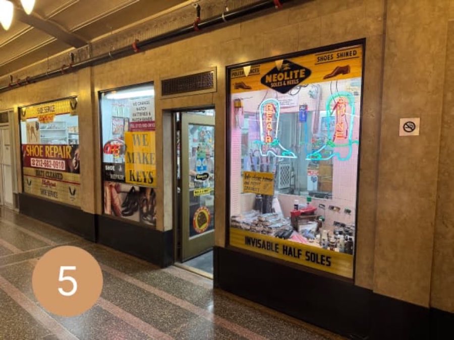 The real AK Shoe Repair storefront in the Chanin Building arcade, with a neon "REPAIR" sign and a window full of shoe-care displays