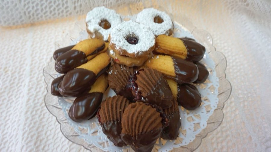 Assorted chocolate-dipped cookies and pastries on a plate