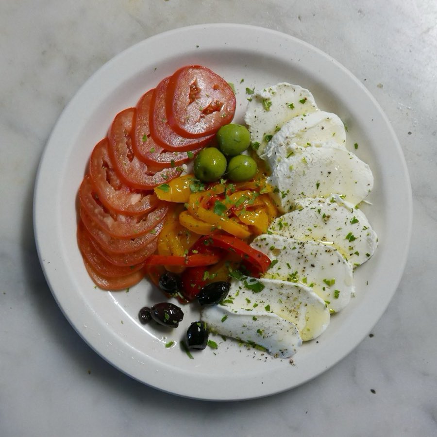 Sliced prosciutto with fresh mozzarella and tomato