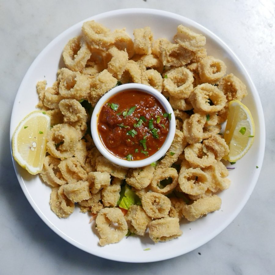 Fried calamari with marinara dipping sauce and a lemon wedge