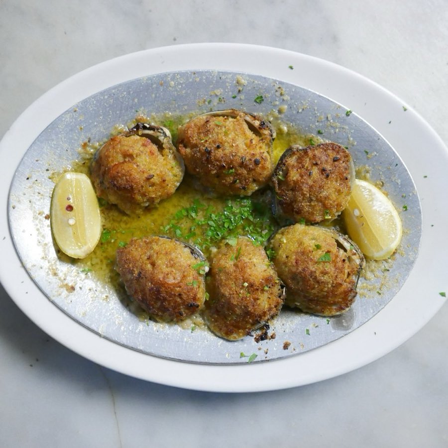 Meatballs garnished and plated on a white dish