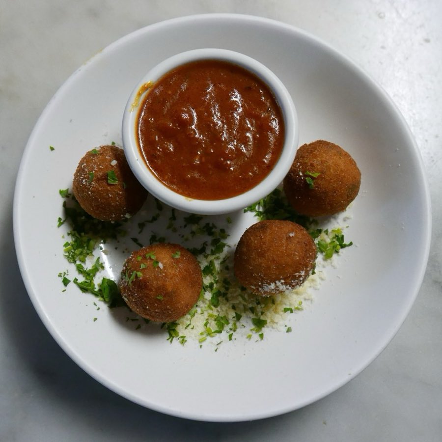 Fried rice balls served with marinara dipping sauce