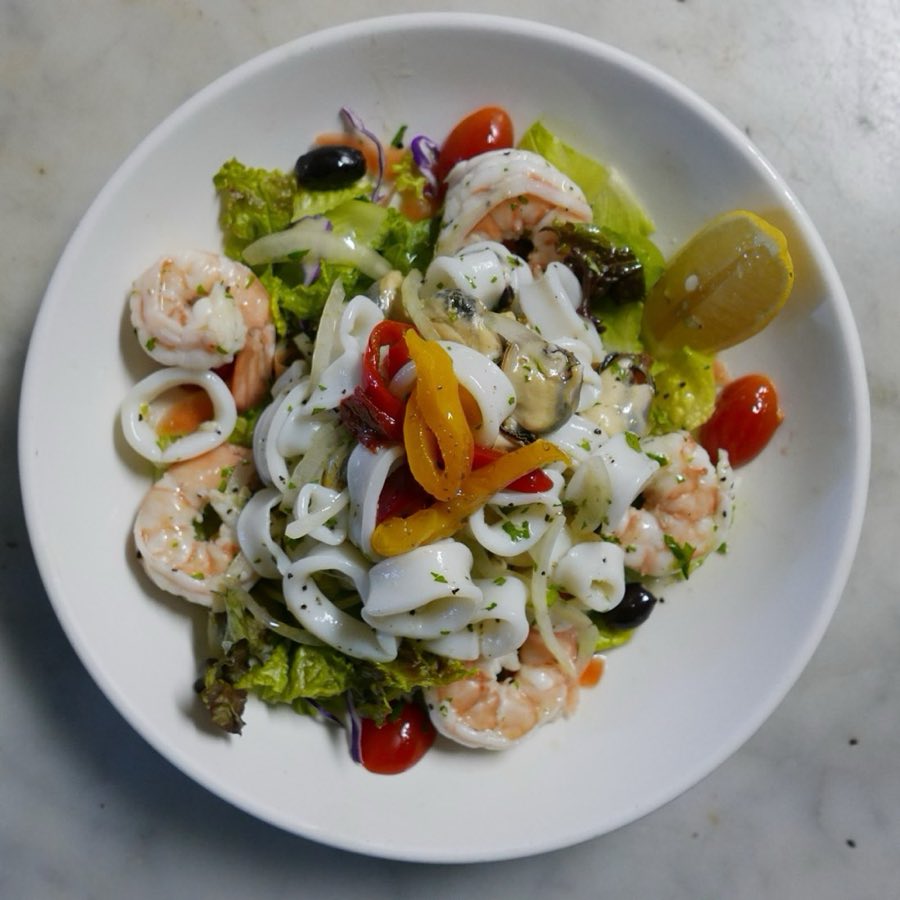 Seafood salad with shrimp and a lemon wedge