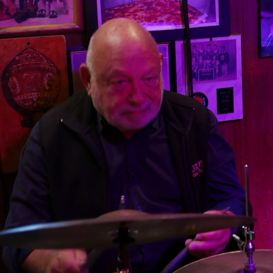 A musician performing solo, bathed in warm red light
