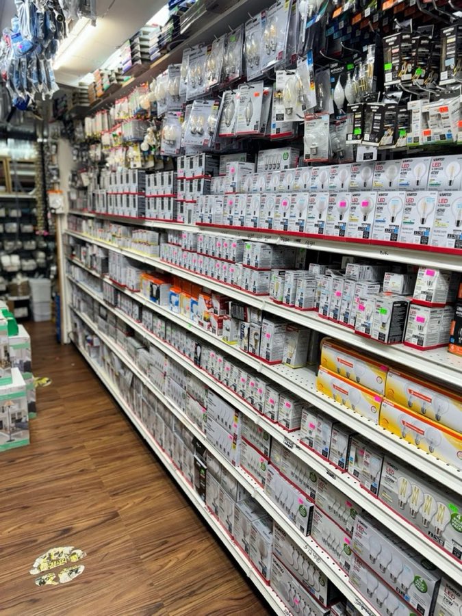 Aisle of LED and incandescent light bulbs on shelves