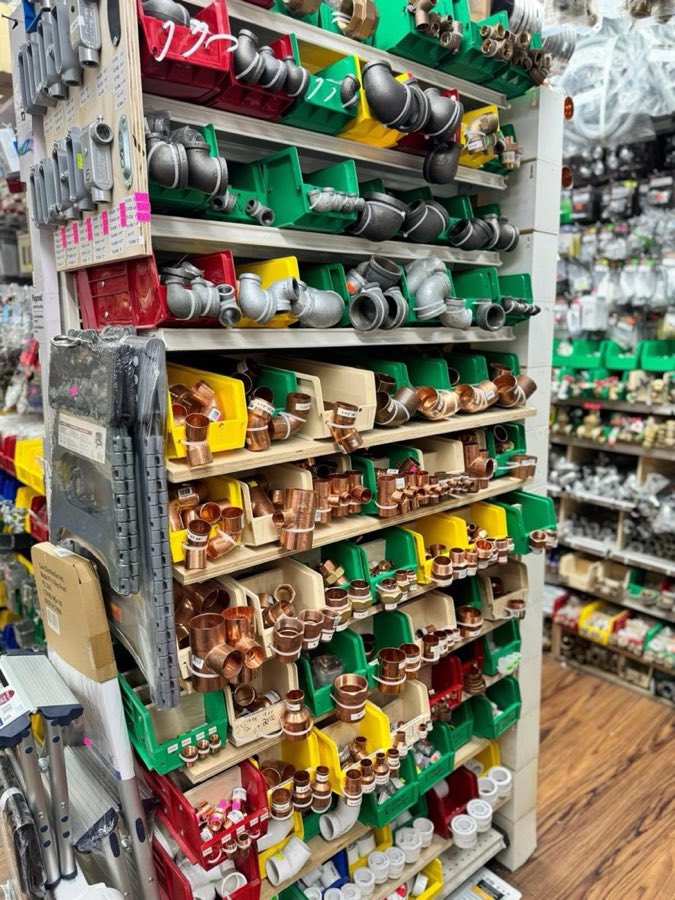 Shelves of copper and galvanized plumbing fittings in bins