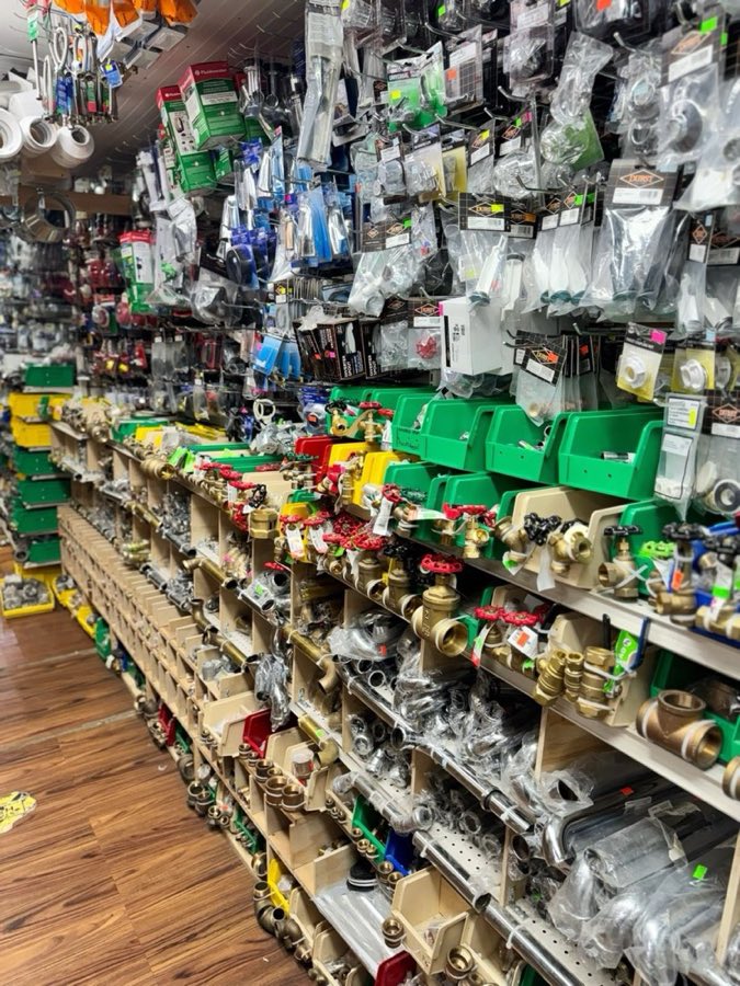 Brass ball valves and plumbing fittings hanging on display