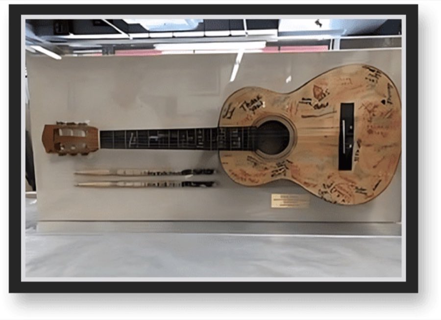 A signed acoustic guitar mounted and custom-framed in a museum display case at Columbus Art Gallery