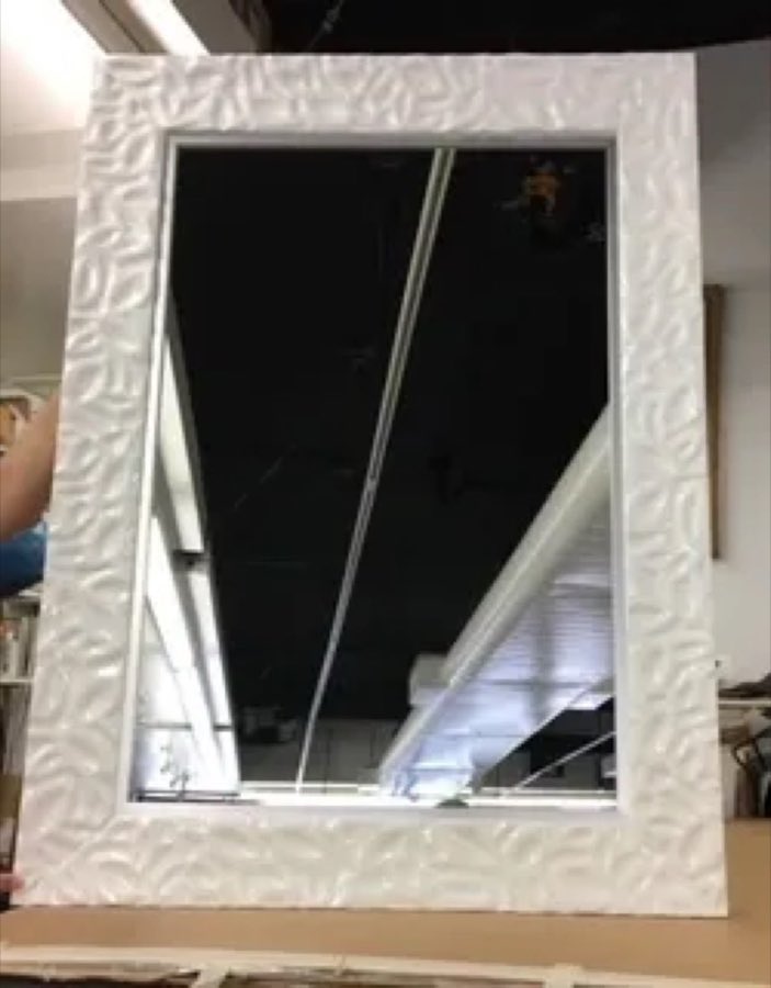 A custom textured silver and white decorative mirror frame