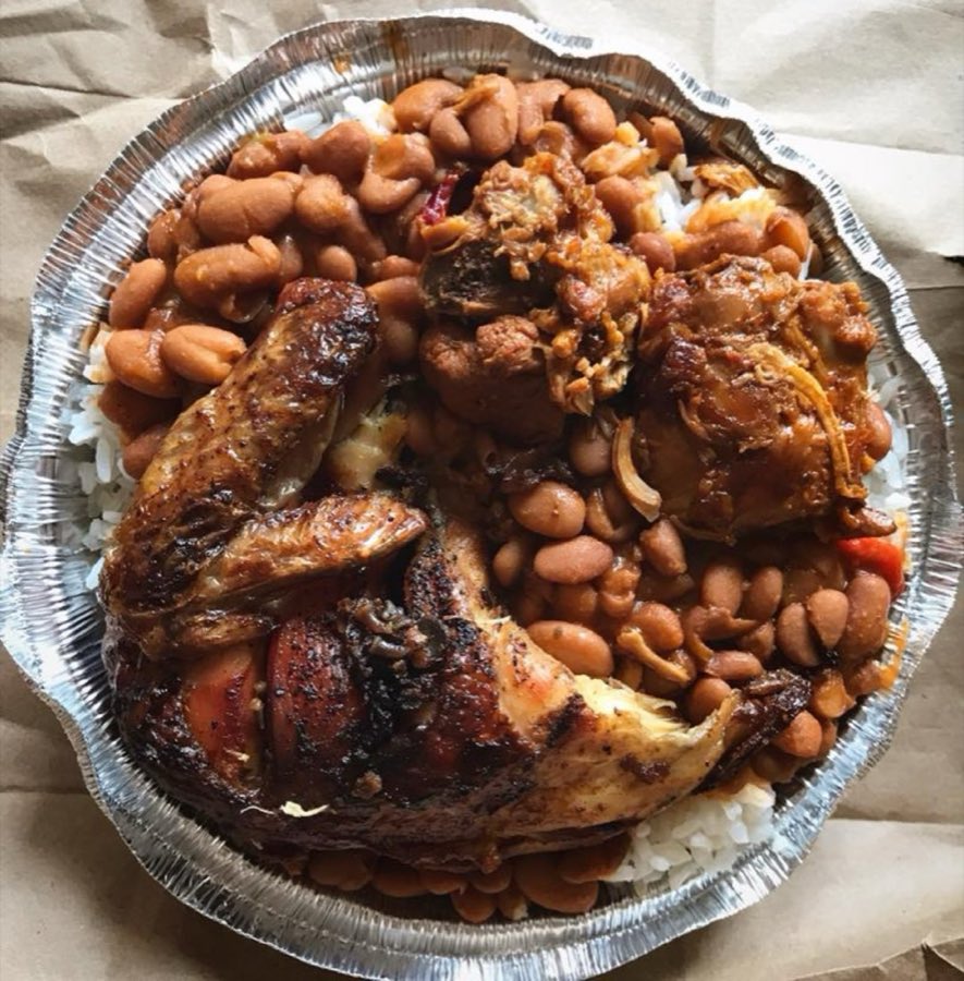 Takeout tray of grilled chicken pieces over white rice and beans, a real freshly prepared meal from Don Juan