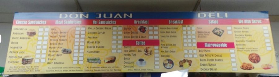 Photo of the actual in-store menu board at Don Juan Deli, listing sandwiches, breakfast, coffee, salads, and sides with checkbox order squares
