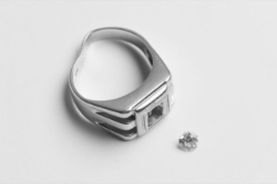 A worn white-gold ring missing its center stone, before repair