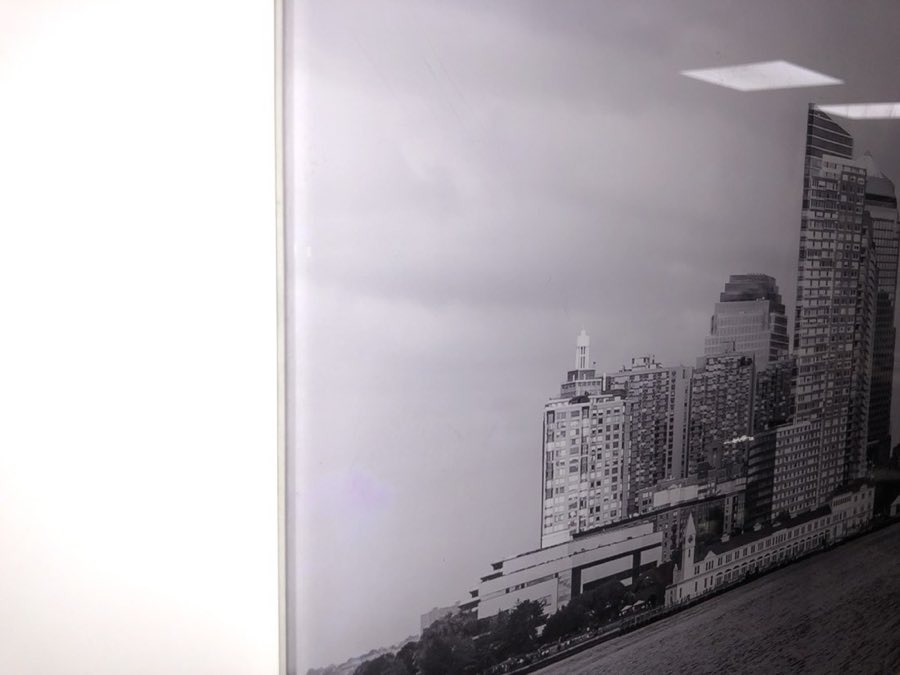 A finished black-and-white framed print of the New York City skyline, on display in the shop
