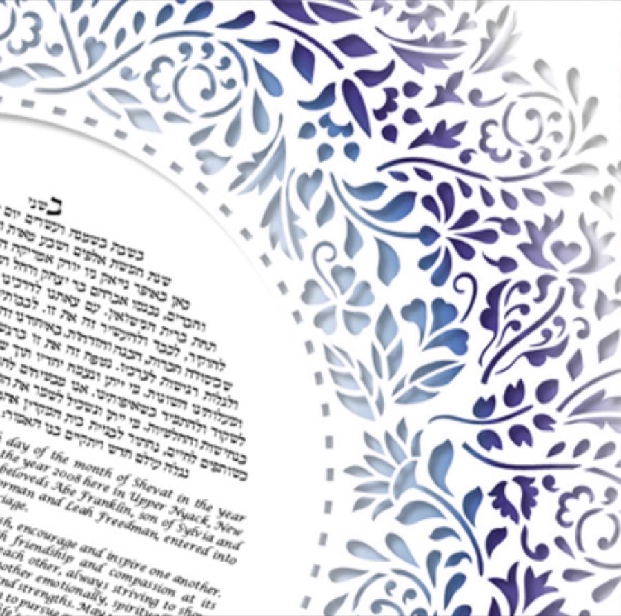 A framed ketubah with an ornate blue and purple papercut-style floral border