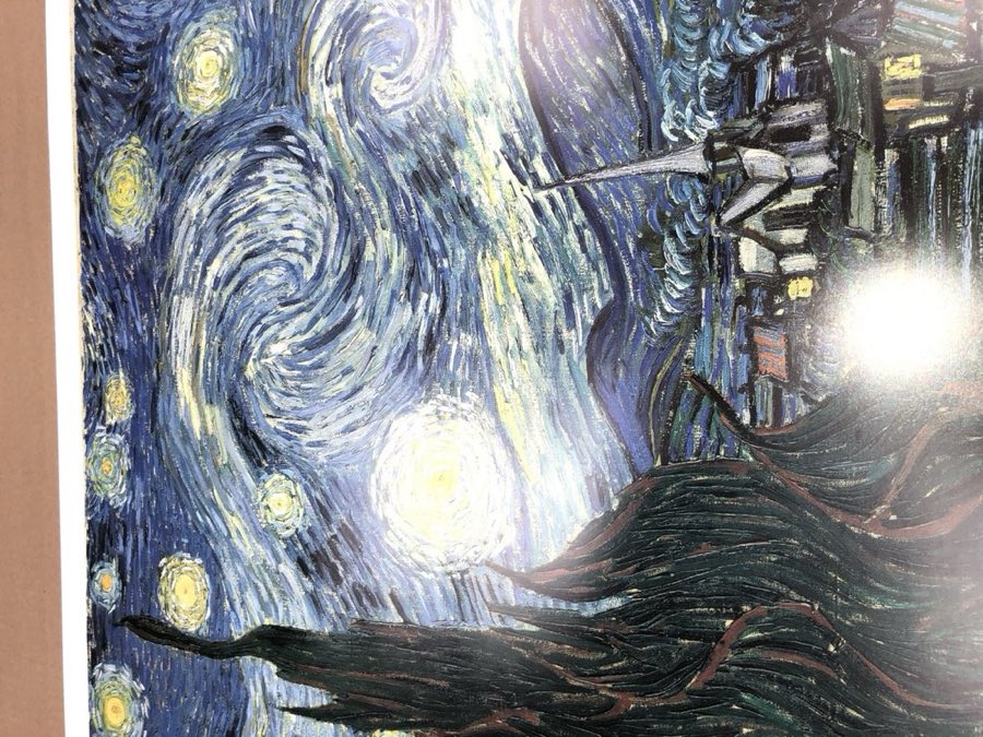 A reproduction print of Van Gogh's The Starry Night being matted and framed
