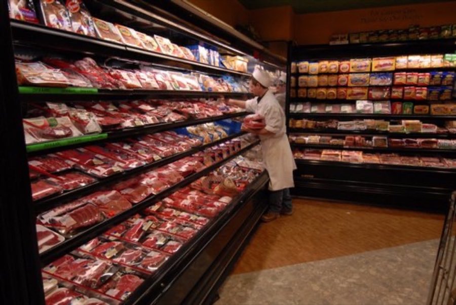 Custom butcher shop counter with a wide selection of raw meats on display