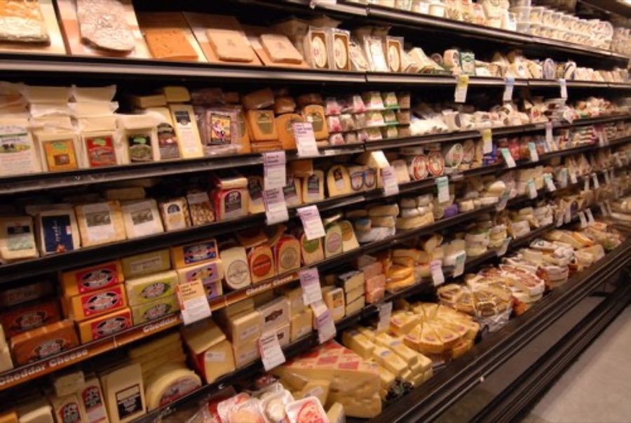 Cheese case aisle stocked with packaged cheeses