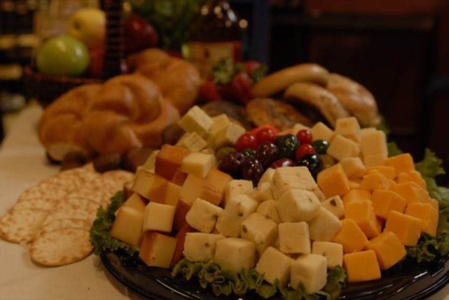 Cheese platter with crackers and fresh fruit