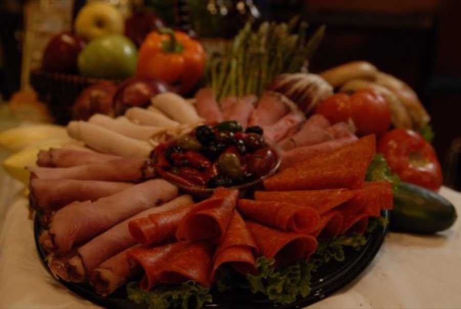 A rosette-arranged fine meat deli platter of roast beef, turkey breast, ham, pastrami and corned beef