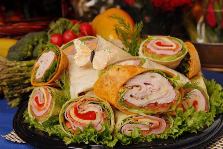 Wrap platter with sliced rolled sandwiches fanned across a tray