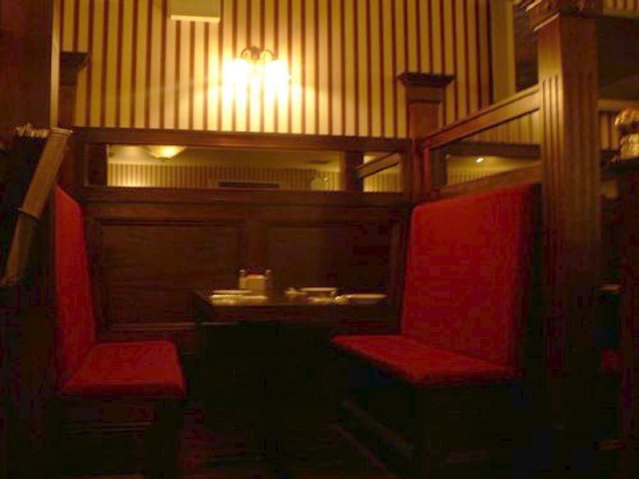 A red private dining booth inside Jake's Saloon