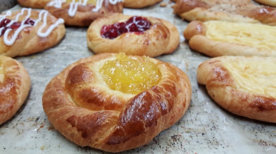 Assorted fruit danishes on a bakery tray