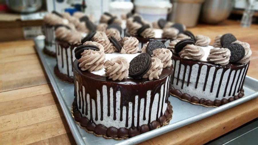 Oreo chocolate drip cakes on a bakery table