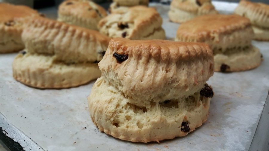 Raisin scones stacked on a bakery counter