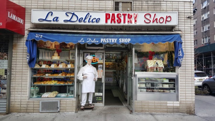 La Delice storefront with George standing in the doorway