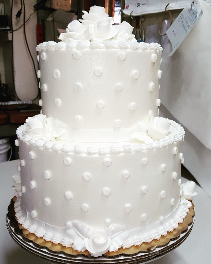 White tiered wedding cake with delicate decoration