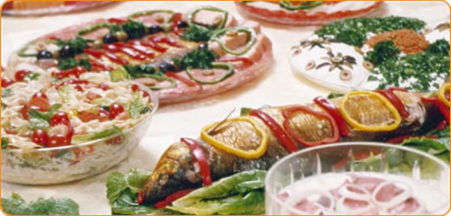 An overhead spread of Murray's catering platters — decorated fish and garnished salads on a table