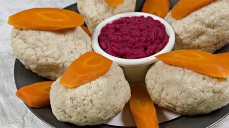 Rounds of chopped-fish salad garnished with carrot slices, arranged around a dish of magenta beet horseradish