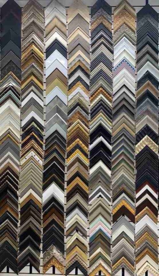 Close-up of seven more framing corner samples, ornate and gilded finishes in gold, blue, and patterned wood