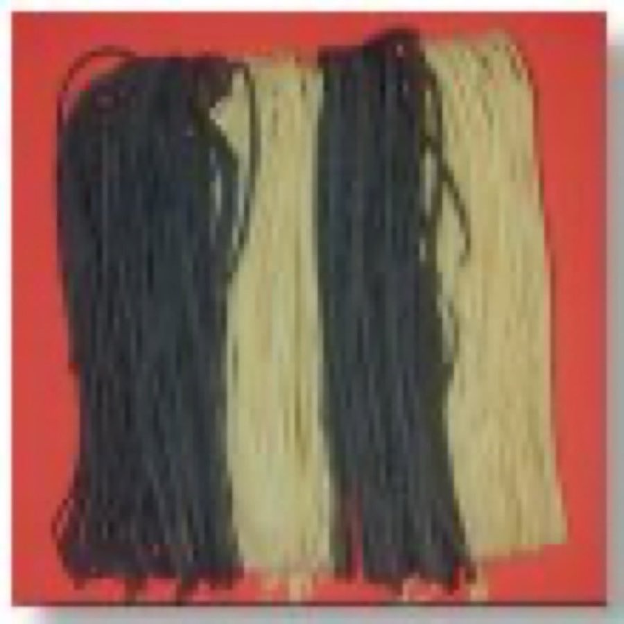 Four coiled nests of angel hair pasta in white, spinach, squid-ink, and tomato