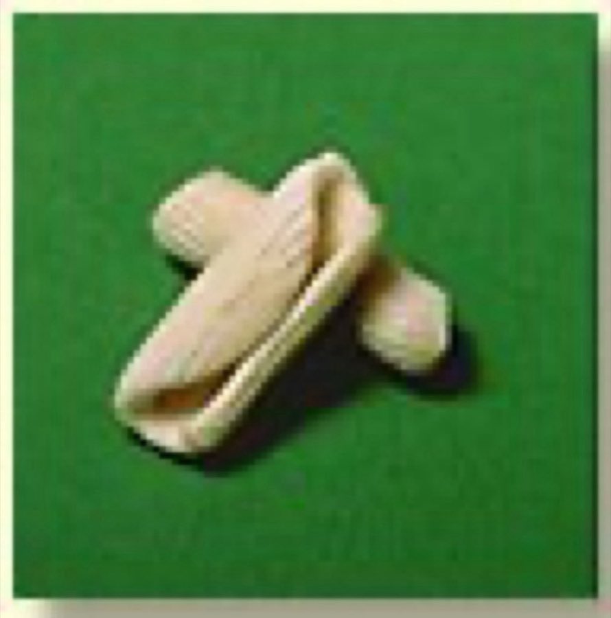 A single cavatelli piece on a green background
