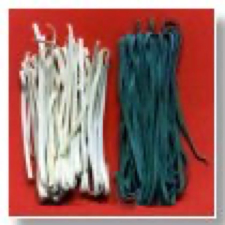 Three coiled nests of fresh linguine — plain white, squid-ink black, and tomato orange