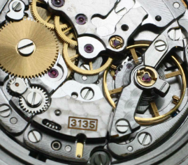 Macro photo of an open mechanical watch movement, caliber 3135, showing gear trains and jeweled bearings