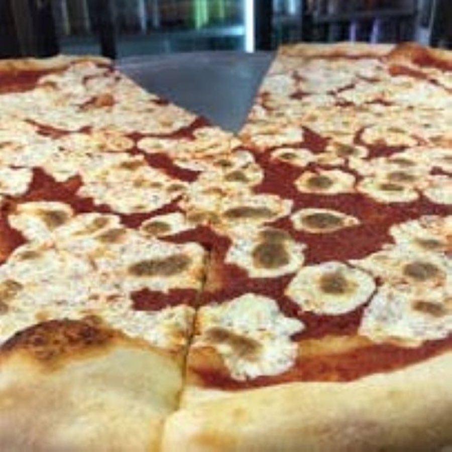 A margherita pizza with fresh mozzarella and tomato sauce, mid-slice
