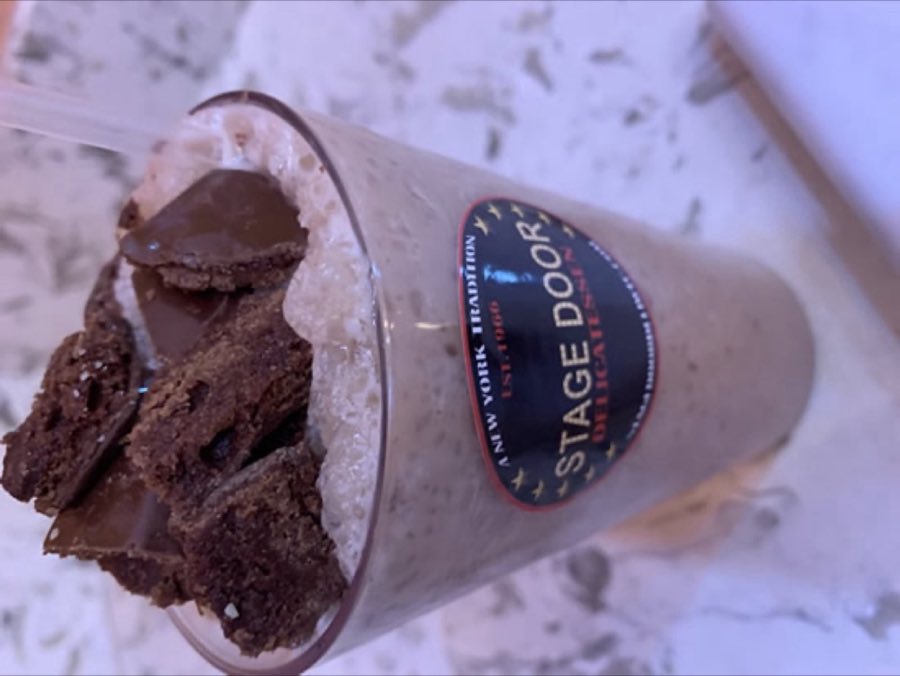 A frozen blueberry smoothie in a branded Stage Door cup