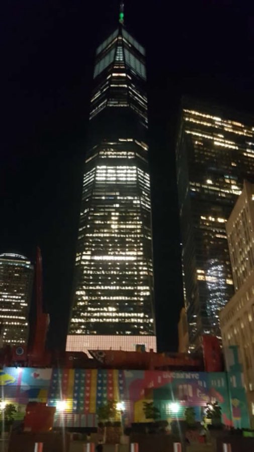 One World Trade Center lit up at night, viewed from the street near Vesey Street