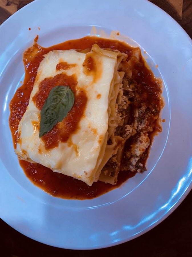 A slice of lasagna plated for the hot food menu