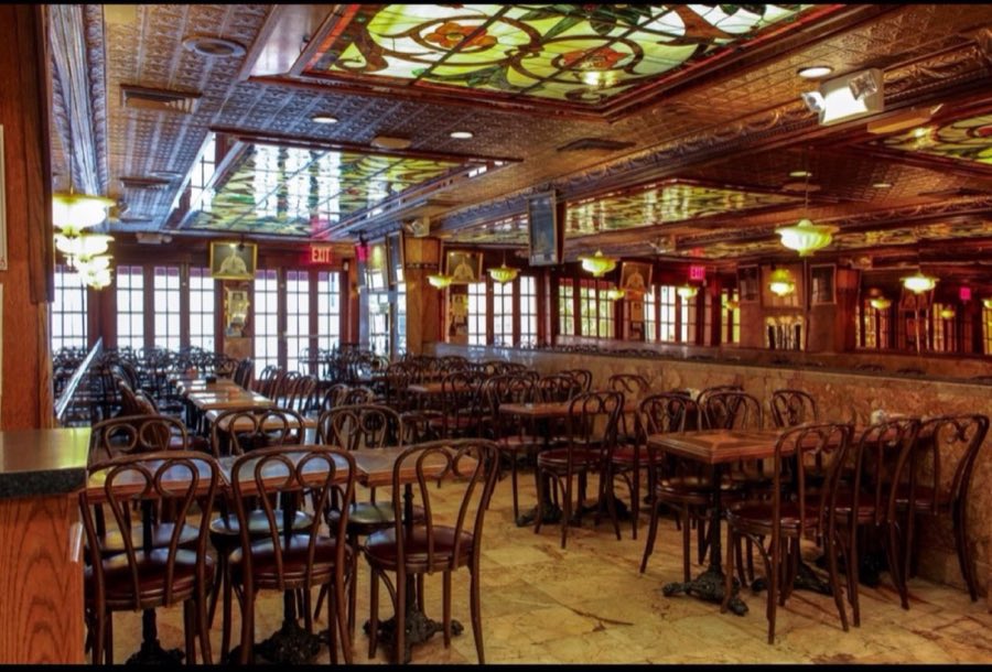 Veniero's café dining room with stained-glass ceiling panels, pressed tin ceiling tiles, marble-topped bentwood tables and chairs